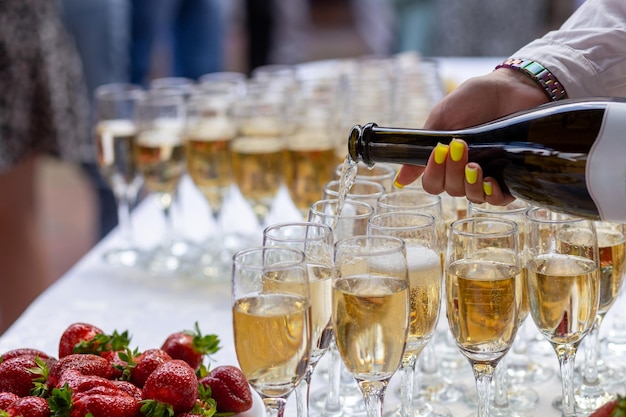 A banquet table with wine glasses and plates with strawberries