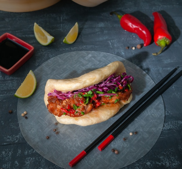 Bao burger with chicken fillet with tonkatsu sauce.