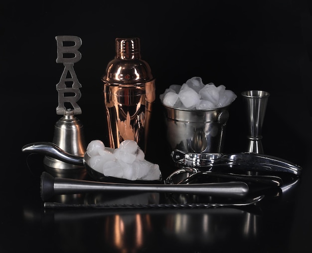 bar accessories for drinks isolated on black background