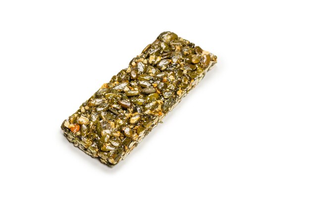 Bar with nuts isolated on a white background. Pumpkin seeds bar. Top view.