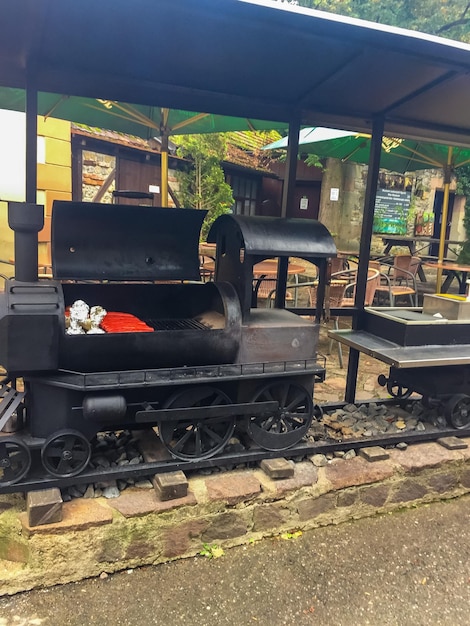 Barbecue grill with meat in shape of old steam locomotive karlstein