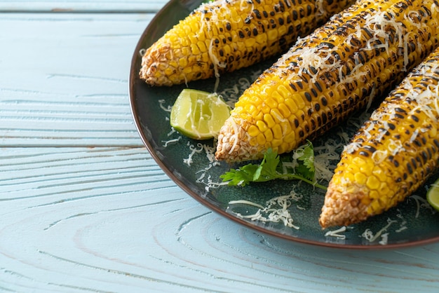 Barbecue and grilled corn with cheese and lime