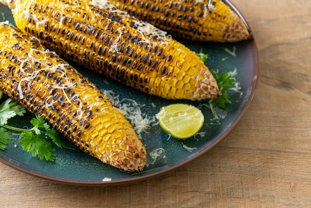 Barbecue and grilled corn with cheese and lime