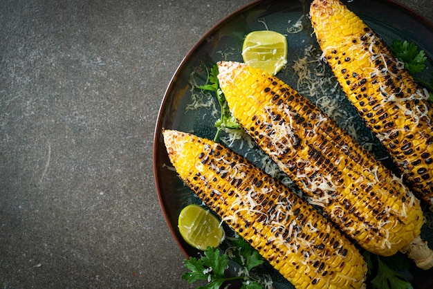 Barbecue and grilled corn with cheese and lime