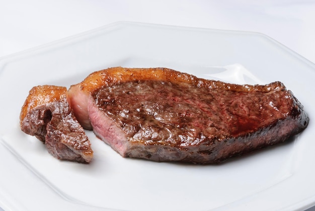 Barbecue meat steak on a white plate Brazilian barbecue