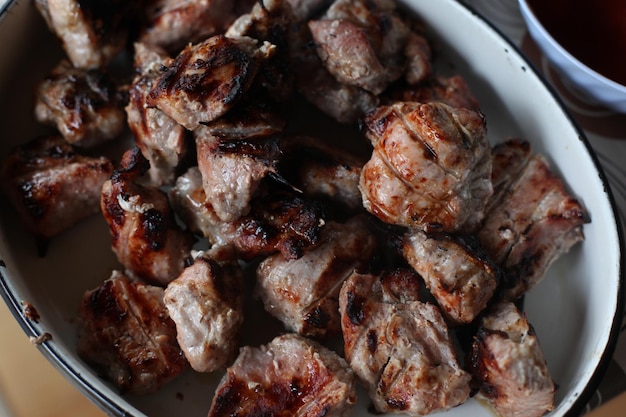 Barbecue pieces of meat in marinade fried on coals Summer days