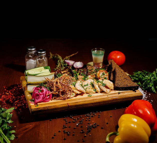 Barbecue ribs, and french fries with sauce on a wooden plate. Dish with a lot of fried meat.