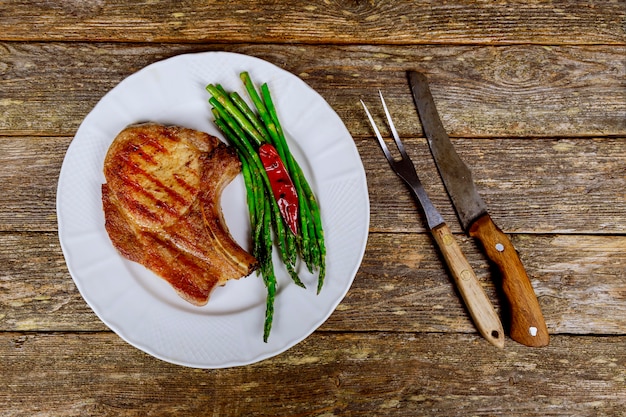 Barbecue Steak with green Asparagus and Mushroom a rusty wood sheet