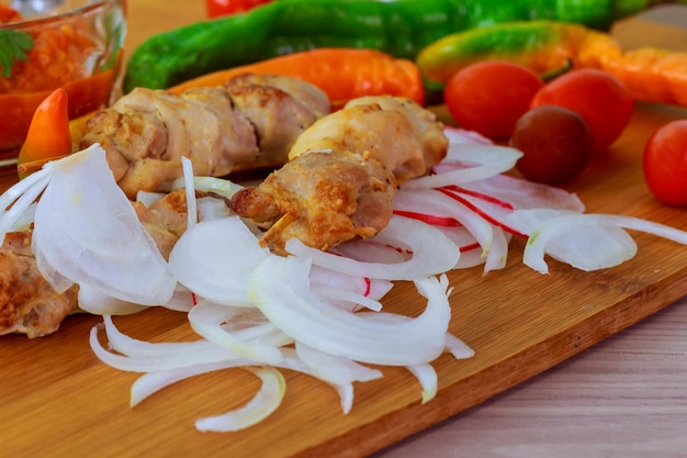 Barbecue with delicious grilled meat on grill chicken skewers onion pepper adjika