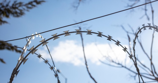 Barbed wire fence against sky