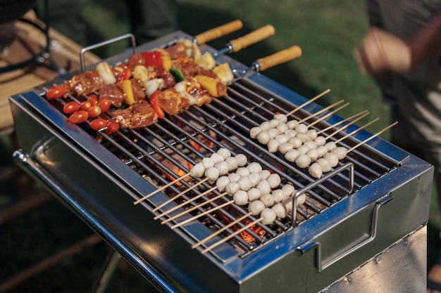 Barbeque skewers meat with vegetable and meatball grilling on charcoal bbq grill in backyard