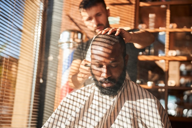 Barber applying talcum powder on client neck