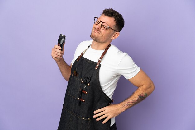 Barber caucasian man isolated on purple background