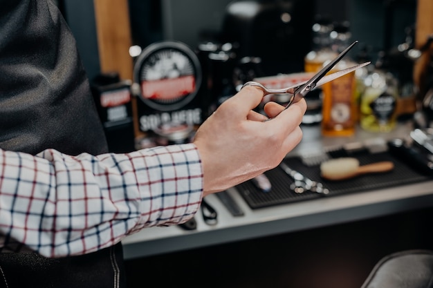 Barber holding scissors at the barber shop