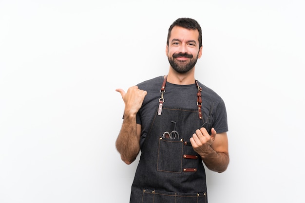 Barber man in an apron pointing to the side to present a product