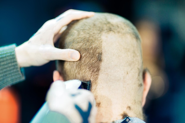 Barber's hands shaving the nape of a customer