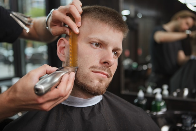 Barber shaving a client at the salon