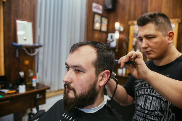 Barber shop, a man with a beard cut hairdresser