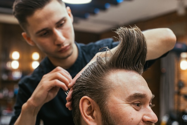 Barber shop, a man with a beard cut hairdresser. 