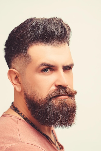 Barbershop concept Portrait of attractive severe brutal bearded man has a perfect hairstyle modern stylish haircut