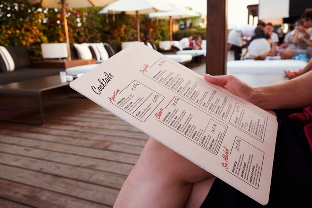 Photo barcelona july 29 2016 customer holds la isabela hotel s rooftop bar menu mid section