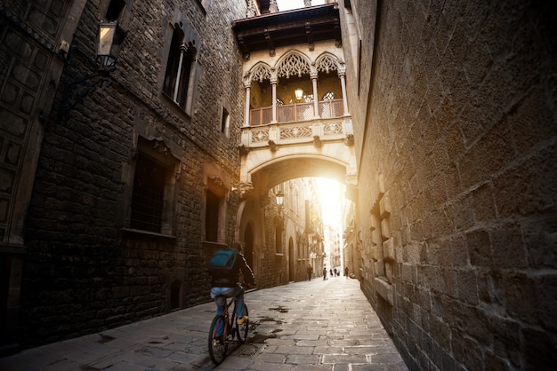 Barcelona people biking bicycle in Barri Gothic Quarter in Barcelona, Catalonia, Spain.