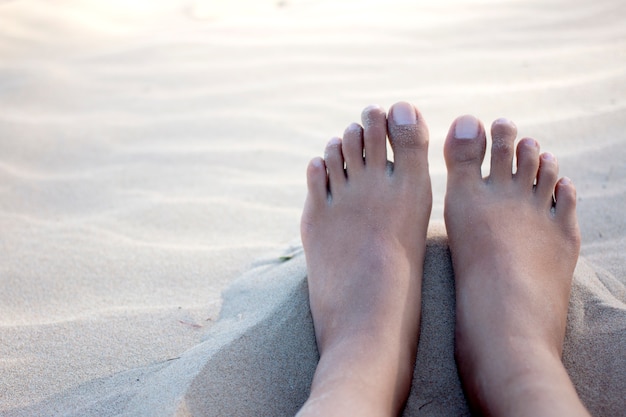 bare feet on warm white sand.