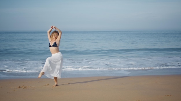 Barefoot dancer performing beach summer day tender woman moving sensually