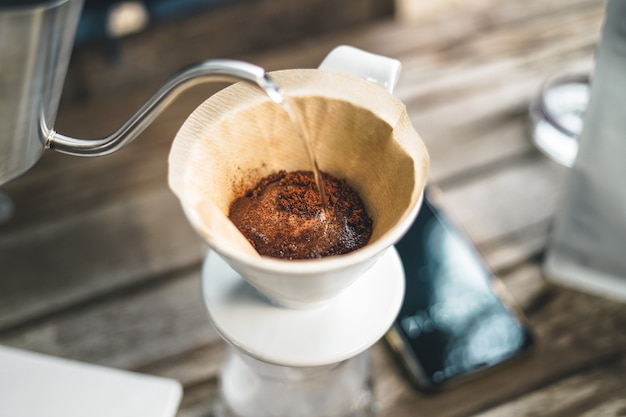 Barista dripping coffee and slow coffee bar style drip coffee