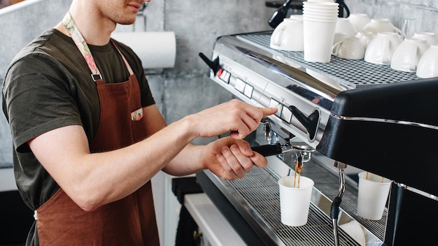 Barista. Hand making the coffee closeup