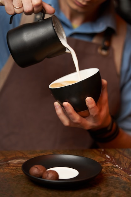 Barista making cappuccino, close-up