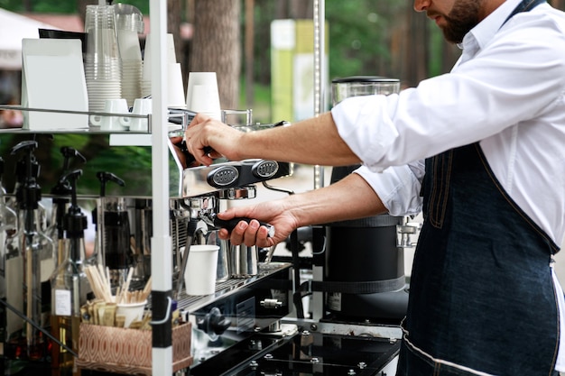 Barista making coffee using professional espresso machine. Work in details.