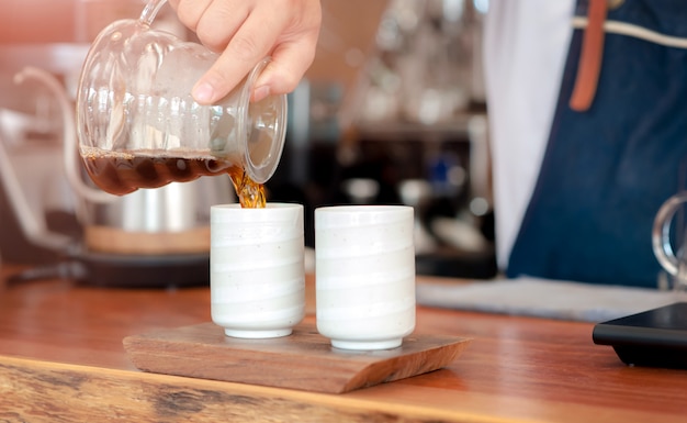 Barista making coffee with pouring