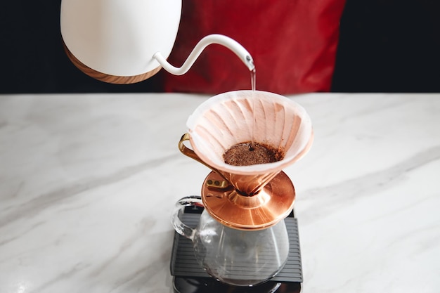 Barista making pourover coffee with a hario v dripper closeup