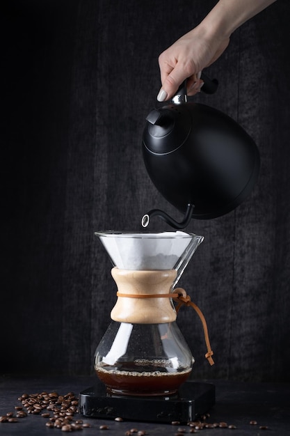 Barista pouring coffee with chemex