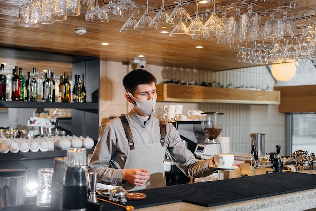 The barista prepares coffee in a modern cafe.