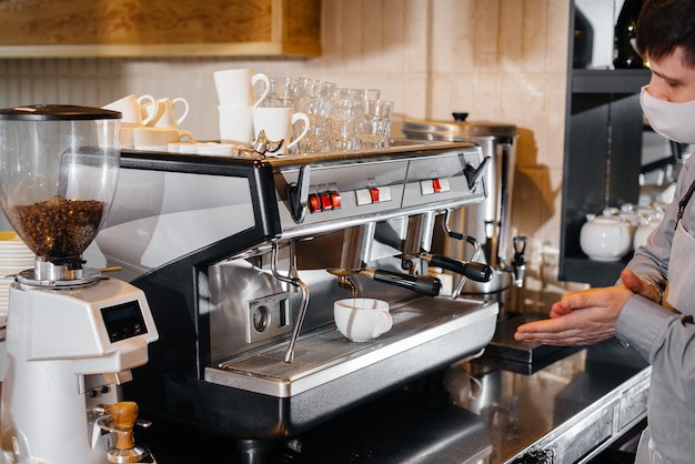 The barista prepares coffee in a modern cafe.