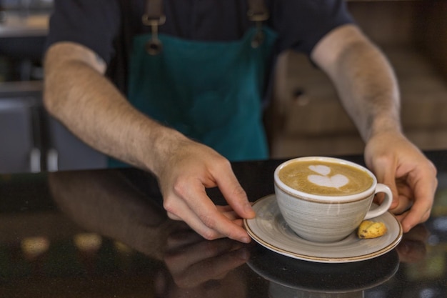 Barista serving latte coffee