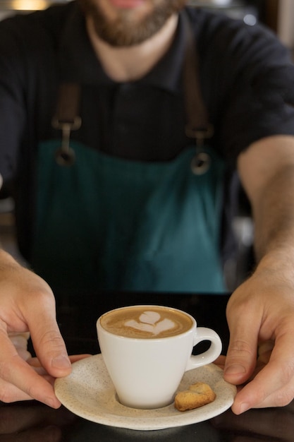 Barista serving latte coffee