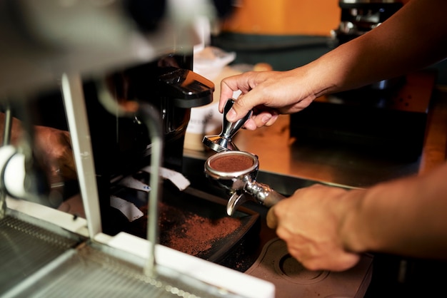 Barista tamping arabica grounds