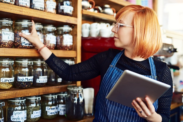 Barista woman and tablet for cafe menu or online order on website in startup coffee shop Small business owner waiter and review with technology for stock inventory or price checklist in store