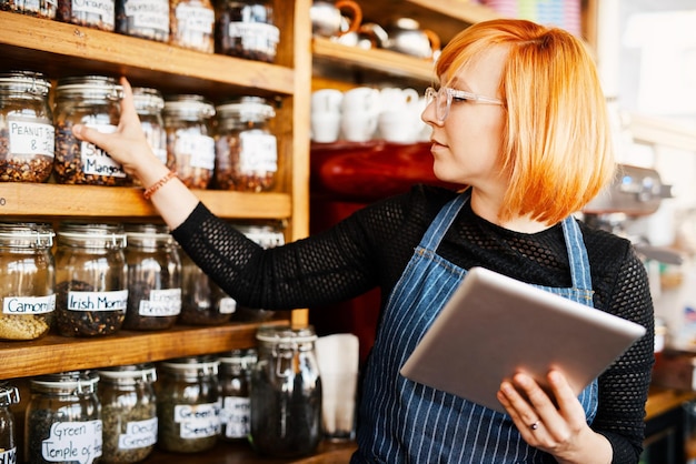 Barista woman and tablet for menu checklist or online order on website in startup cafe Small business owner waiter and review with technology for stock inventory or coffee shop price in store