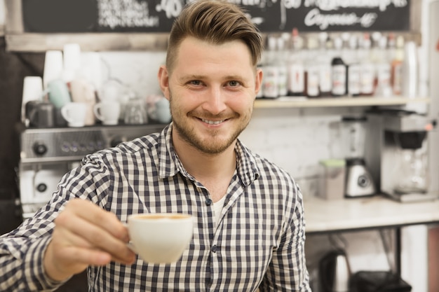 Barista working at his coffee shop