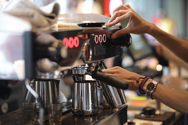 Baristas hands making a coffee with espresso coffee machine Coffee shop concept