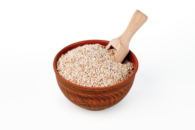 Barley groats in bowls and bags isolated on a white background High quality photo