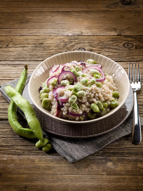 Barley risotto with beans broad and onions vegetarian food