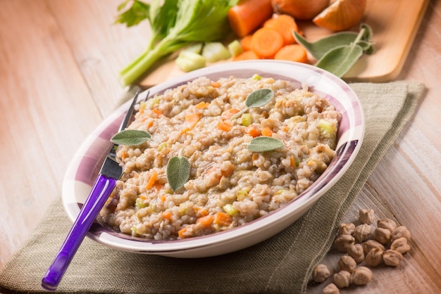 Barley risotto with chickpeas and vegetables selective focus