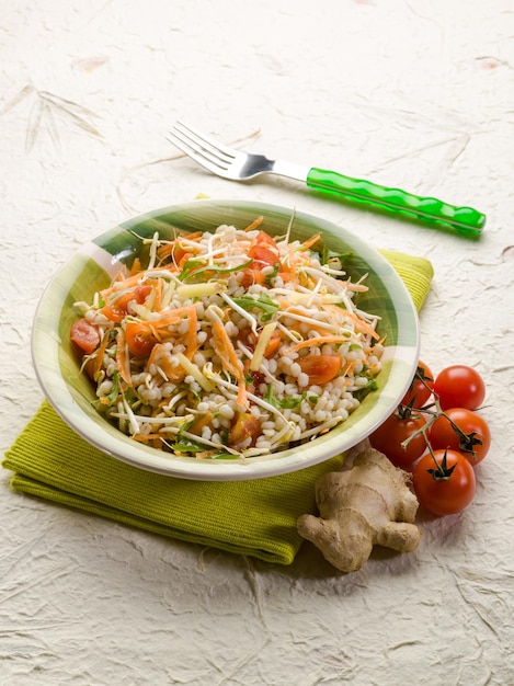 Barley salad with ginger carrots arugula and tomatoes