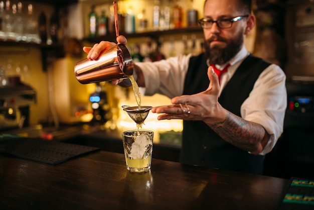 Barman flaring behind bar counter