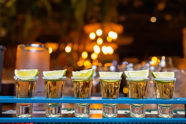 Barman make alcoholic shots with rum and liquor